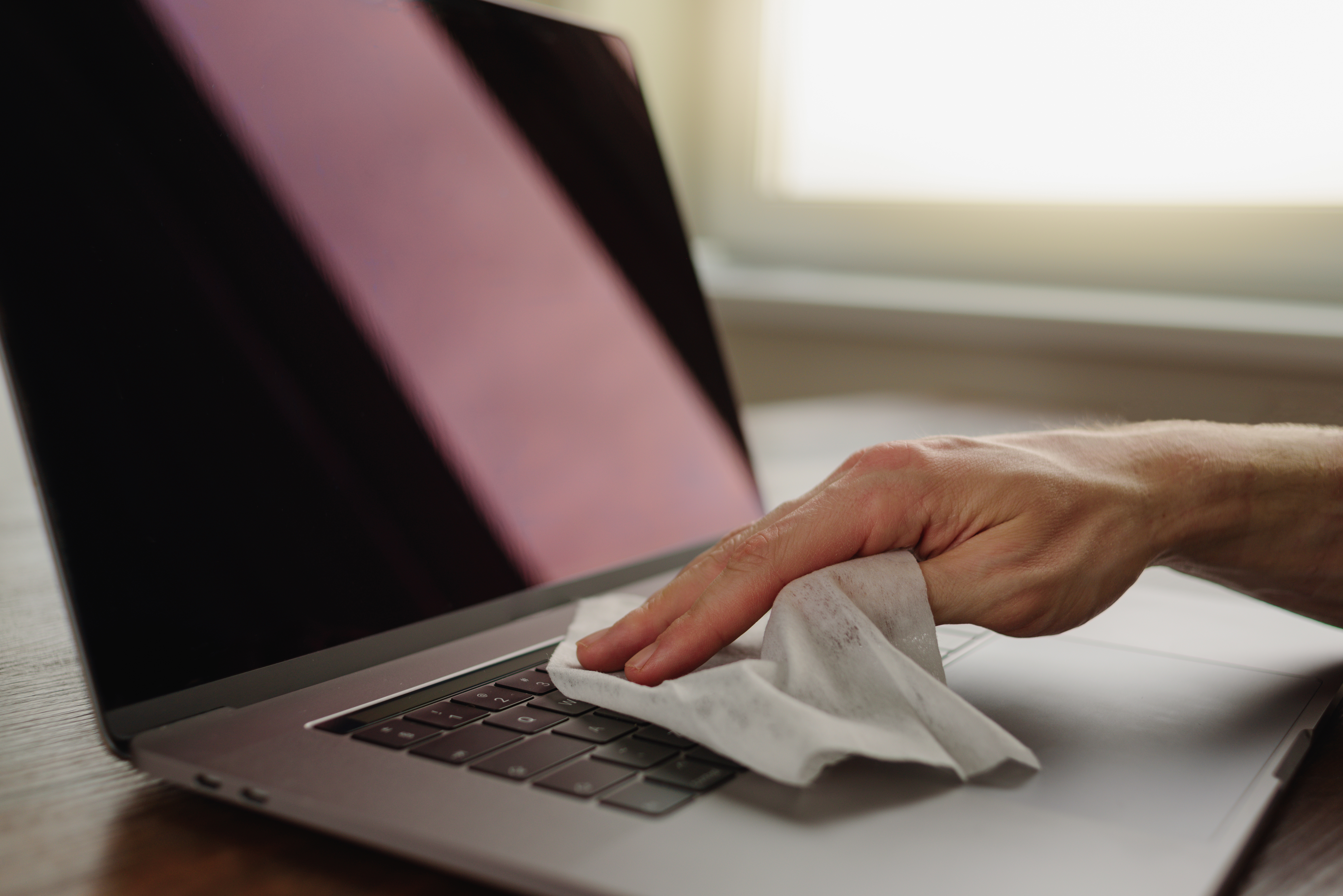 cleaning-laptop-keyboard-with-wet-wipe-2023-11-27-05-16-21-utc.jpg