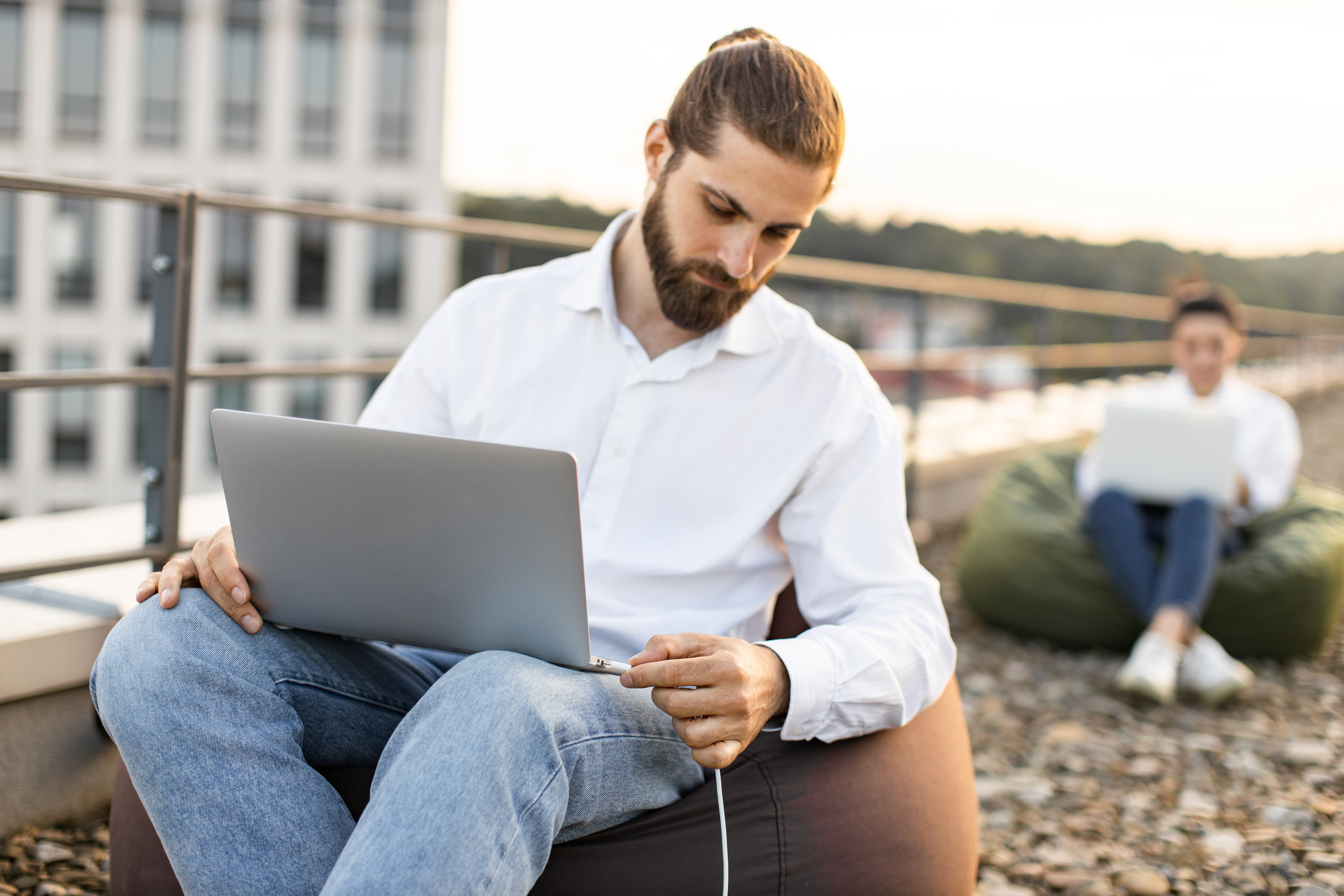 business-man-connects-charging-cable-to-laptop-out-2024-08-09-01-12-28-utc.jpg