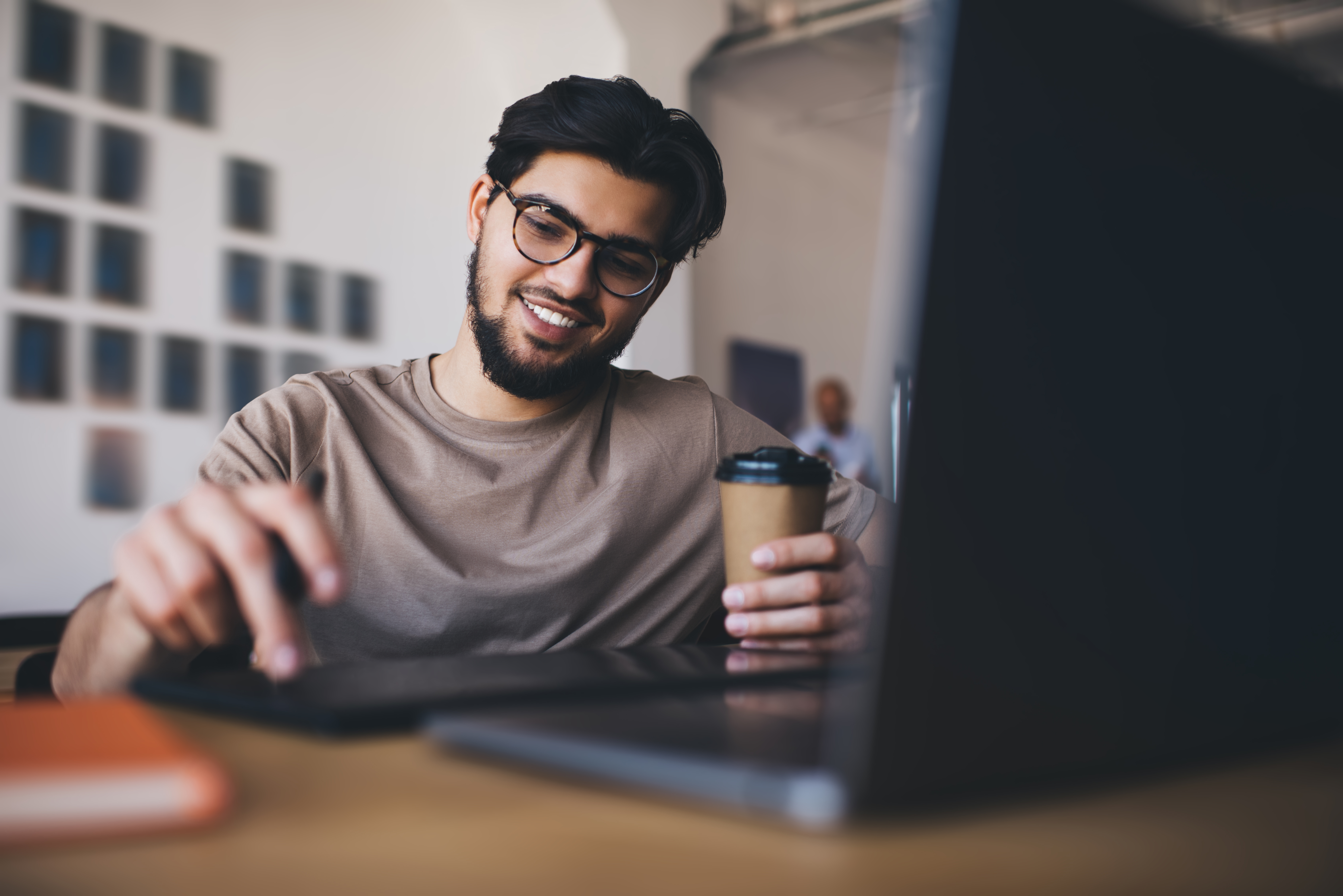 happy-man-with-laptop-and-coffee-2024-01-31-15-08-11-utc.jpg